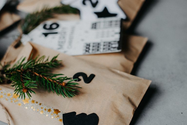 Close-up of a decorated advent calendar with evergreen sprigs for a festive touch.